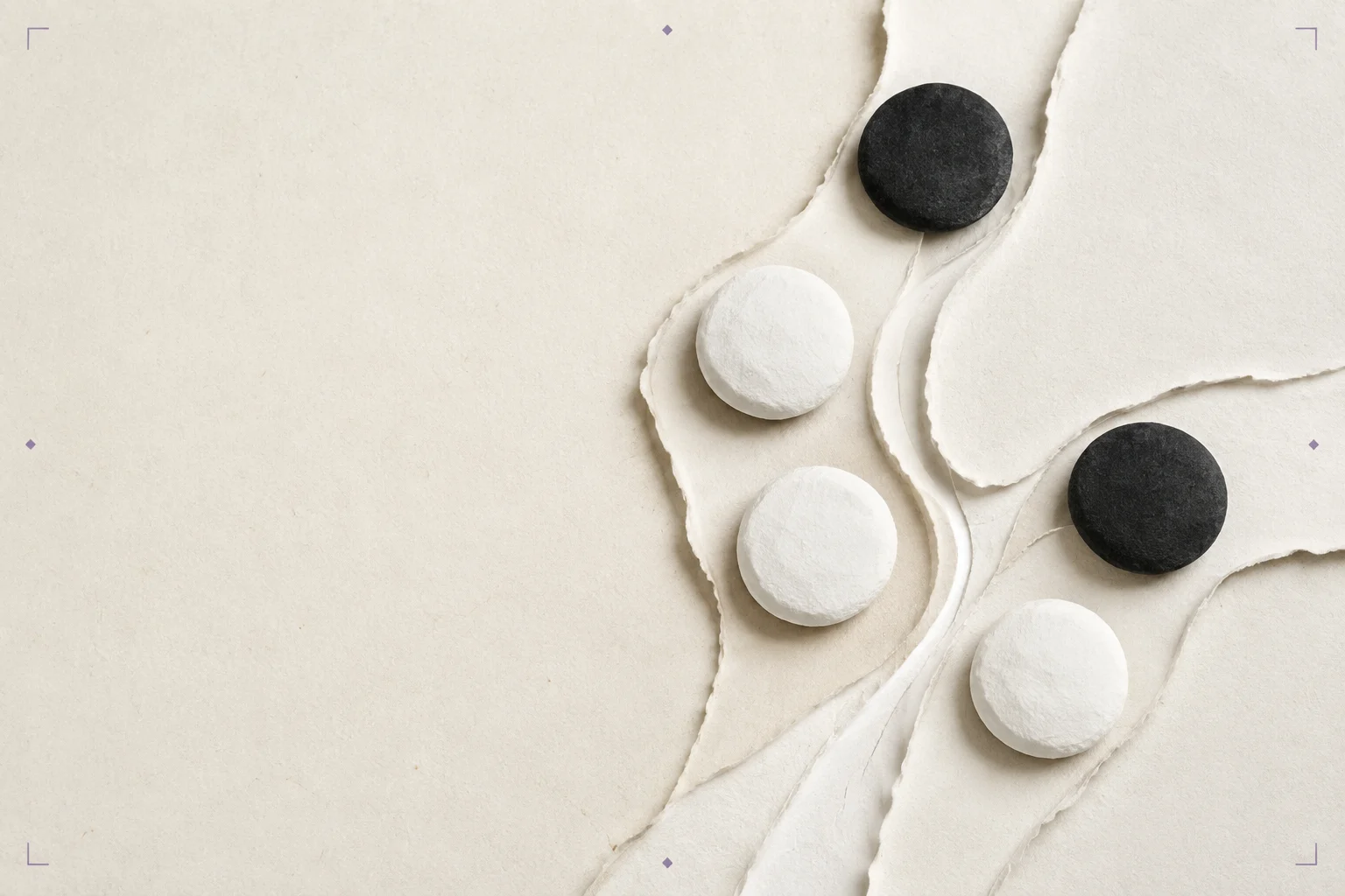 White and black cut-paper Go stones beside diverging folded paths on warm paper.